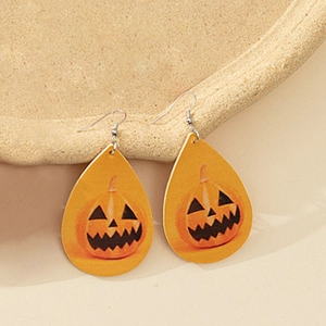 Detail shot of teardrop earrings featuring Halloween pumpkin lanterns on faux leather