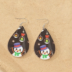 Close-up of wooden teardrop earrings with colorful cartoon snowman and Christmas patterns