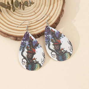 Detailed view of teardrop acrylic earrings with Halloween dark castle print