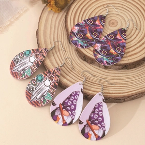 Three pairs of teardrop acrylic Halloween earrings with ghost, witch hat, and gnome patterns
