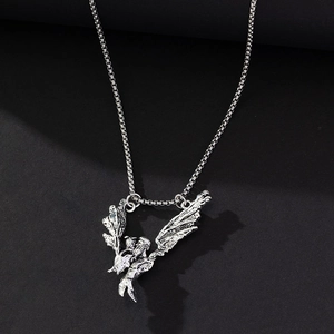 Vintage silver dragon wing pendant necklace with square box chain on a matte grey surface