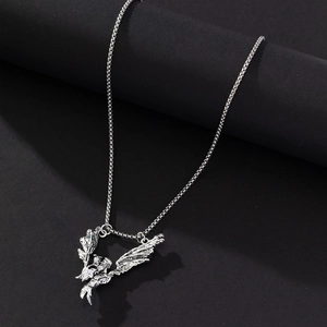 Detailed close-up of antique silver dragon wing pendant on a stylish box chain necklace