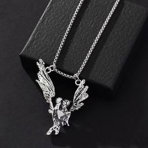 Vintage silver angel lovers pendant with wings on box chain over black jewelry box
