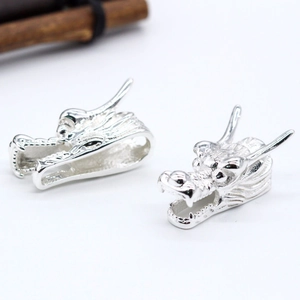 Vintage silver metal dragon head pendant charms with detailed carvings for jewelry making