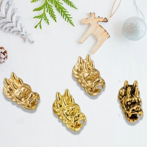 Close-up of golden Chinese dragon head beads for DIY jewelry making and bracelets