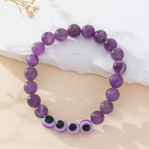 Handmade amethyst beaded bracelet featuring purple natural stones and evil eye charms