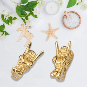 Macro view of two golden dragon head pendants with intricate vintage metal carving