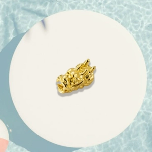 Detailed golden dragon head charm bead showing intricate scales and zodiac craftsmanship