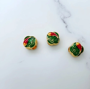 Detailed macro view of green enamel koi fish beads with gold filigree for jewelry DIY