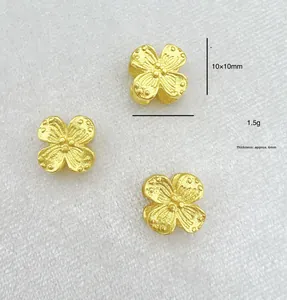 Detail of 10x10mm gold hollow clover bead with 6mm thickness and matte texture finish