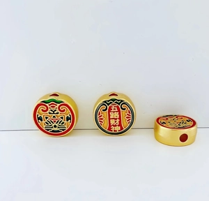 Close-up of golden alloy Five Roads God of Wealth bead with colorful enamel finish