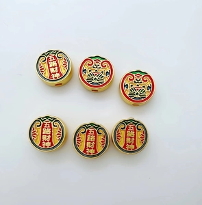 Macro view of gold-plated enamel beads featuring traditional five gods of wealth motifs