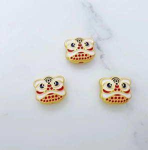 Detail of colorful enamel lion head beads for DIY jewelry with traditional Chinese design