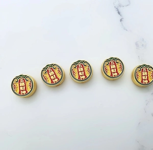 Detailed view of five colorful enamel Five Roads Wealth God beads in gold finish