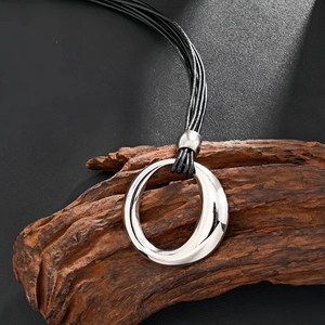 Minimalist silver irregular round pendant necklace with black wax rope on wood