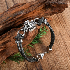 Men's woven black leather bracelet with silver metal cross and skull charm detail