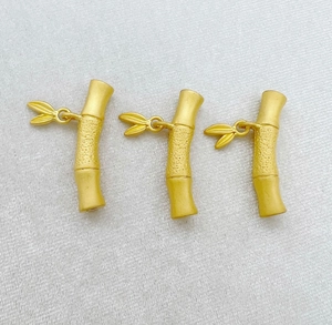 Three matte gold bamboo tube beads with leaf detail for DIY jewelry making and crafts