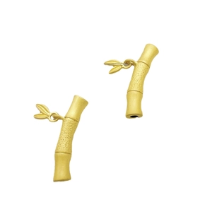 Pair of matte gold bamboo shaped DIY jewelry connectors with delicate small leaves
