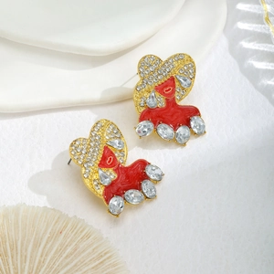 Detailed close-up of a vintage style red bow snowman earring with shiny clear zircons