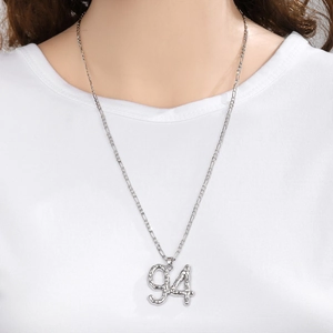 Detail of Saudi National Day 94 alloy necklace pendant with textured silver surface