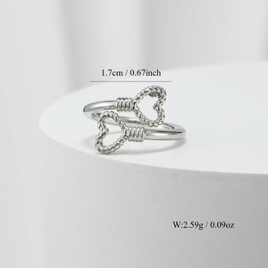 Detail view of silver heart ring with twisted band design including size and weight specs