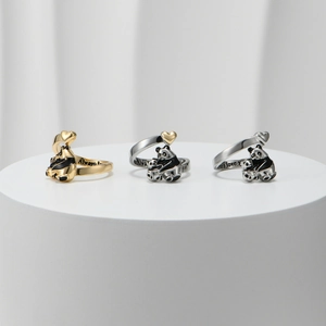 Detailed close-up of panda rings with hearts and Always love you engraved inside