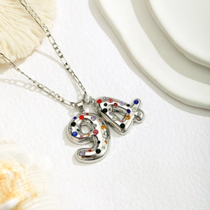 Close-up of number 94 pendant necklace with multicolor crystals on Figaro chain