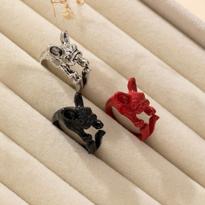 Detailed view of creative French Bulldog rings in silver, black and red finishes
