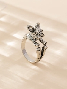 Detail of a 3D French Bulldog adjustable ring in vintage silver metal with retro texture