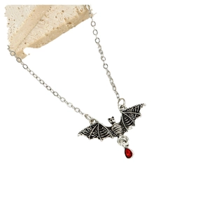 Gothic silver-toned bat necklace with a bright red teardrop gemstone pendant