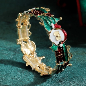 Weihnachtsarmband mit Weihnachtsmann und Stechpalmen-Anhänger auf goldener Metallbasis