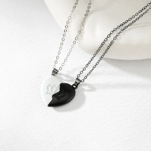 Detailed close-up of magnetic heart pendants with crown relief on textured background