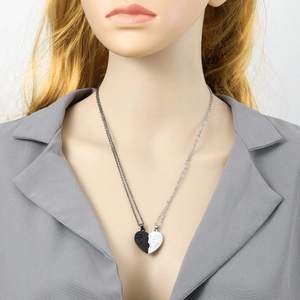 Close-up of heart-shaped magnetic puzzle necklace with face profile engraving for couples