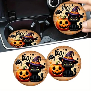 Close-up of Halloween car coasters with black cat and pumpkin design in a cup holder