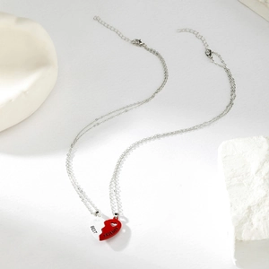 Detailed view of silver split-heart magnetic necklace engraved with Best Friends text