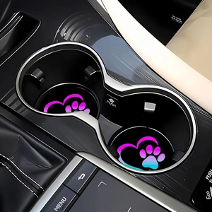 Macro detail of dual car coasters with glowing heart and paw print in a vehicle cup holder