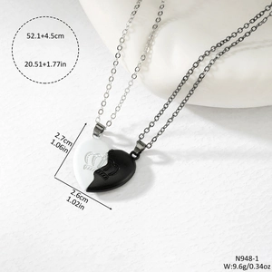 Magnetic heart pendant necklace set with crown engraving and black and white enamel finish