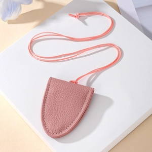 Detailed close-up of a pink textured leather bell-shaped keychain charm with fine stitching