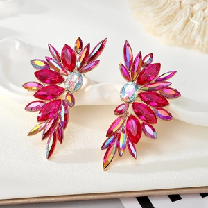 Macro detail of oversized leaf-shaped rose red crystal earrings with golden metal base