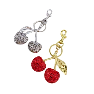 Glittering cherry keychain set with red and white rhinestones on gold and silver metal