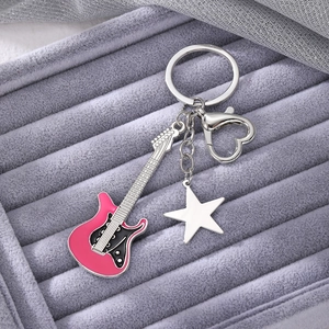 Detailed macro view of Y2K pink guitar keychain with star charm and heart clasp