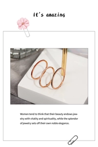 Detailed view of three minimalist rose gold thin stainless steel stackable rings