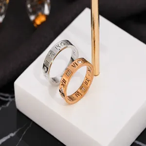 Detail of Roman numeral engravings and embedded zircons on steel rings set