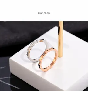 Macro shot of silver and rose gold narrow rings with square grooves and diamond inlay