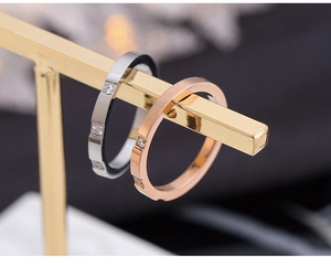 Detail of minimalist stacking rings in silver and rose gold with geometric zircon inlay