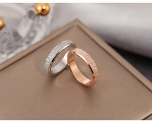 Macro detail of rose gold and silver stainless steel rings with a frosted sandblast texture