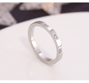 Macro shot of titanium steel ring featuring three sparkling inset cubic zirconia stones