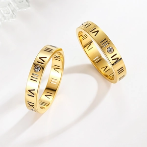Golden titanium steel ring with Roman numerals and zircons in a polished minimalist style