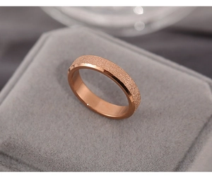 Close-up of rose gold stainless steel ring with matte finish and polished inner band