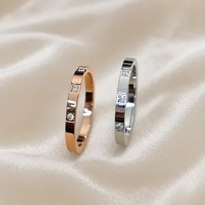 Detailed macro view of slim titanium steel rings with three small inlaid zircons